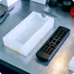 Assortment of polyurethane cast parts replicating properties of polycarbonate and polypropylene.