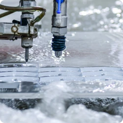 Industrial waterjet cutting nozzle using high-pressure streams to cut precise metal part contours