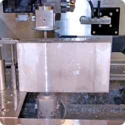 Diverse selection of waterjet-cut material samples in varying thicknesses including metal, rubber, and foam