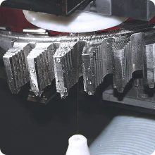 Precision Wire EDM machine cutting a complex profile in a hardened tool steel block with high accuracy