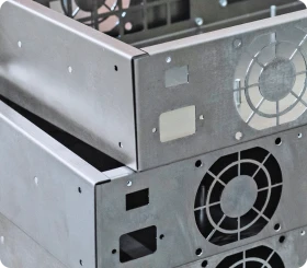 Collection of bent and punched sheet metal components including brackets, panels, and electronic housings
