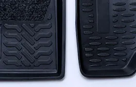 A close-up comparison of two black automotive floor mats, one with a carpet insert and the other made entirely of a textured thermoplastic rubber (TPR) material, a common application where the material's disadvantages like poor heat resistance can be a factor.