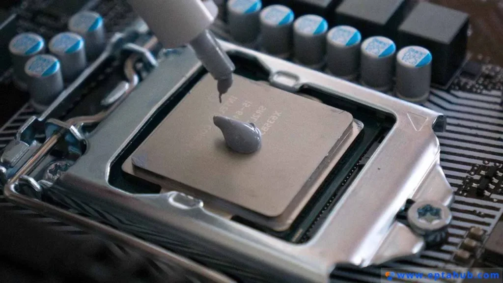A close-up showing the application of thermal interface material (TIM) paste onto a CPU before installing a heat sink, a critical step for ensuring efficient heat conduction.