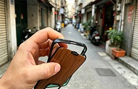 An image from EPTAHUB illustrating a common failure in cheap cases: a two-part phone case with a wood backplate separating from its plastic frame due to poor adhesive or construction.